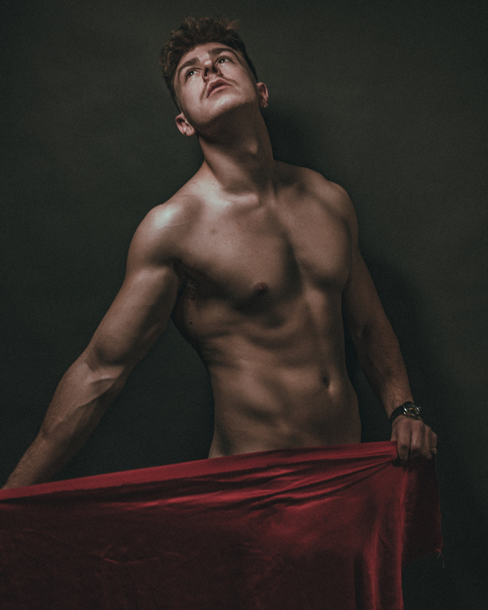 Shirtless Man Holding a Red Towel